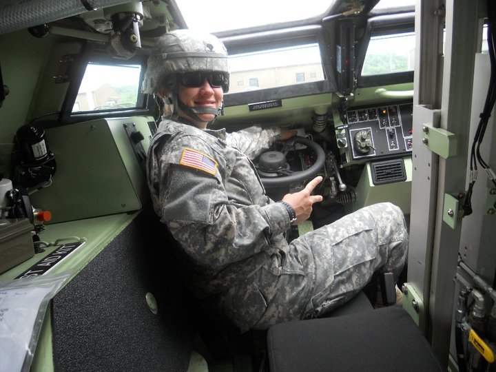 Tania in the driver's seat of a military vehicle