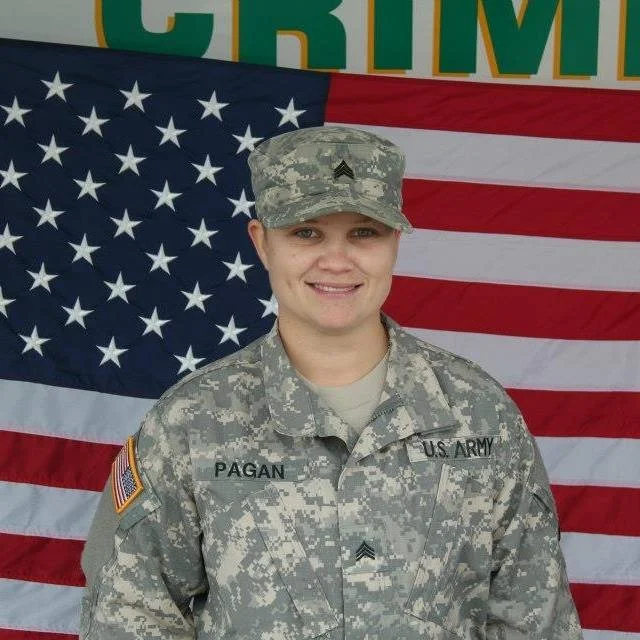 Tania in U.S. Army uniform in front of the American flag